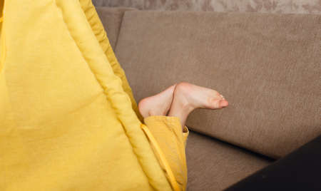 a close-up of a childs legs sticking out of a teepee.の写真素材