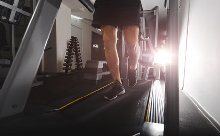 A person running in the gym on a treadmill concept for exercise, fitness and a healthy lifestyle....