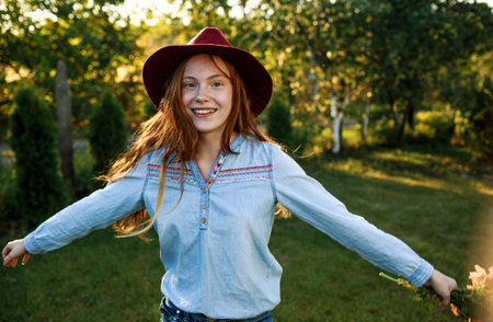 portrait of a red-haired girl in a big red hatの写真素材