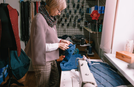 a female designer creates clothes in an atelier or fashion studio.