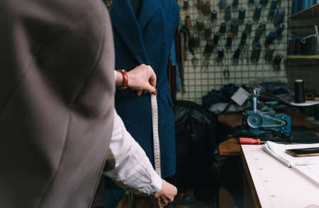 A female fashion designer takes measurements with a centimeter. clothing productionの写真素材