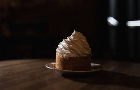A cake basket with protein cream on a black background. One cake on a black background. beautiful lightの写真素材