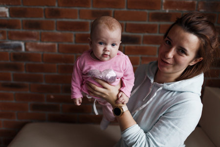 the concept of a family, a happy young mother with a small child at home mom