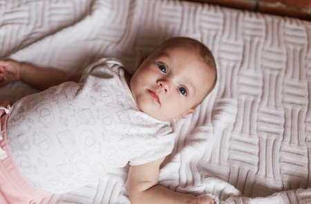 a newborn baby in a crib, the concept of children and the birthの写真素材