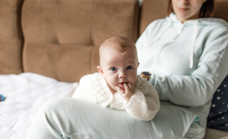 the concept of a family, a happy young mother with a small child at home mom