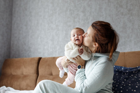 the concept of a family, a happy young mother with a small child at home momの写真素材