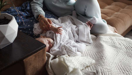 the concept of a family, a happy young mother with a small child at home momの写真素材