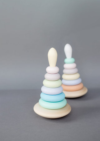 Children's wooden eco-friendly toys pyramids of different sizes of rounded shape on a gray...
