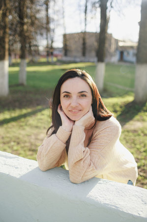 portrait of a young beautiful woman on the street in the park