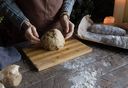 Knead the dough, mix the dough and flour close-up. Pastry chef in a gray apron Cooking at home, cooking recipesの写真素材