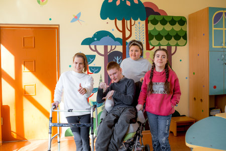 a group of partially disabled teenagers in a rehabilitation centerの写真素材