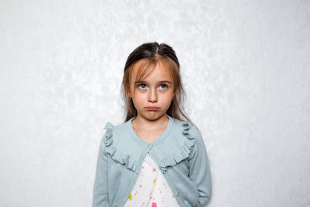 portrait of a sad girl on a light background