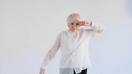 an elderly woman dancing on a white backgroundの写真素材