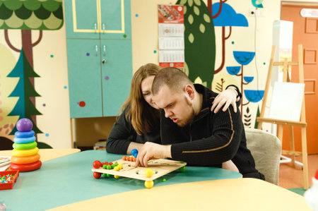 a mother woman is engaged with an autistic son.の写真素材