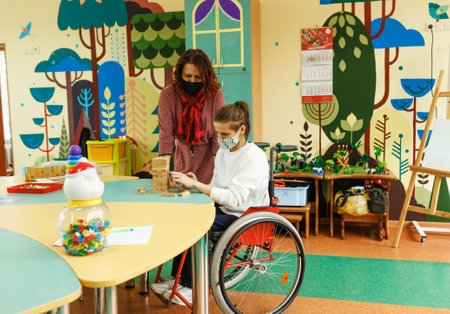 a girl with a nervous mental illness puts together a game in class with a personal psychologist.の写真素材