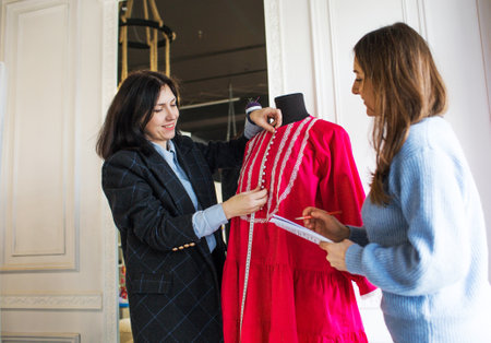 two dressmaker designers create clothes in the studio.の写真素材
