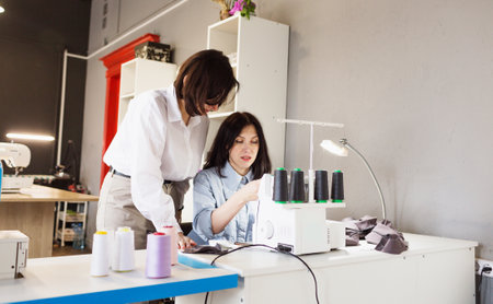 The designer teaches the seamstress the correct tailoring. The concept of creating clothes.の写真素材