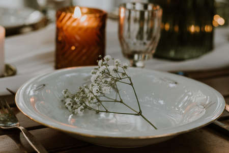 Wedding table setting with glasses, candles and flowersの写真素材