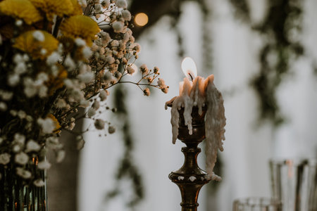Wedding table setting with glasses, candles and flowersの写真素材