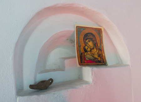 White niche in a church with a postcard of Maria and a small oil lamp in the church of Niehove.の写真素材
