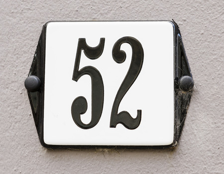 Sign of house number 52 in black karakters on a grey wallの写真素材