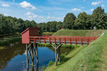 Old red bathroom (toilet) above the moat of the fortress Bourtange in the province of Groningenのeditorial素材