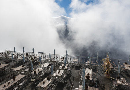 Schynige Platte terrace in Mountains with several chairs and tables in the sun and cloiuds.のeditorial素材