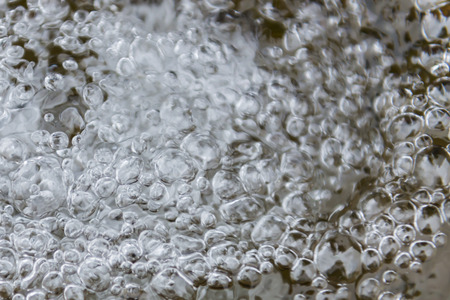 Streaming water with bubbles.の写真素材