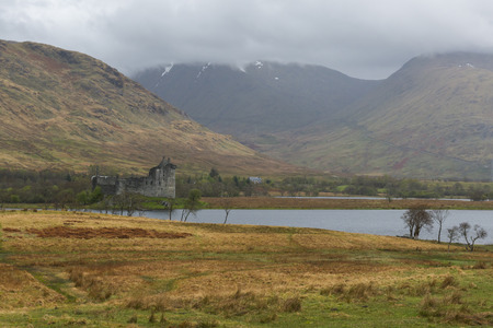 Castle Kilchurn with Loch Awe and mountain in the clouds.のeditorial素材