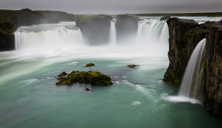 Godafoss Waterfall and river on Iceland with dark sky.