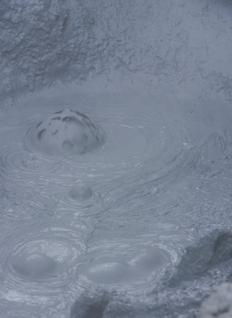 Geothermal landscape Hverarond on Iceland with boiling mud pit with steam.