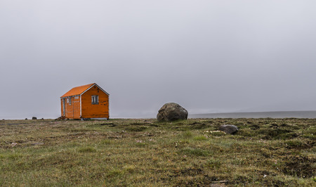 Oarnge cabin and shelter in rainy weather on Iceland.の写真素材
