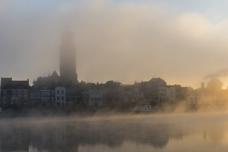 Deventer at the IJssel in the morning during sunrise with the Great Church or Lebuinuskerk and fog  in the province Overijssel, The Netherlands.のeditorial素材
