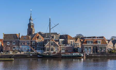 Harbor of Blokzijl in the province of Overijssel with old ship and in the background the church and old monumental houses, The Netherlands.の写真素材