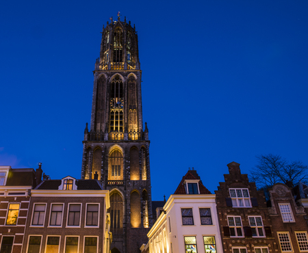 The cathedral (Dom) of Utrecht in the evening light (blue hour) with some houses.のeditorial素材
