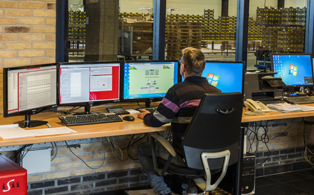 Harmelen, The Netherlands - April 3, 2017: Worker at the control computers desk of a tomato greenhouse.のeditorial素材