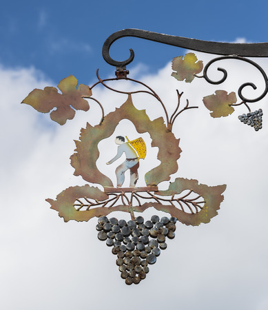 Hautvillers, France - June 9, 2017: Ornament of a man picking grapes with basket in the vinyard, hanging on the wall in Hautvillers in the Champagne district in France.のeditorial素材