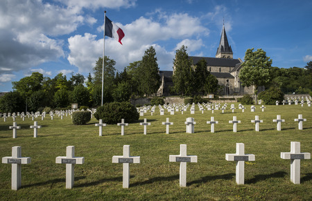Chatillon-sur-Marne, France - June 7, 2017: War cemetery 1914-1918 of French soldiers in Chatillon-sur-Marne with French flag and church.のeditorial素材