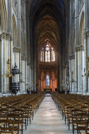 Reims, France - June 12, 2017: interior of the cathedral of Reims with many wooden chairs, high pillars and a pulpitt, France.のeditorial素材
