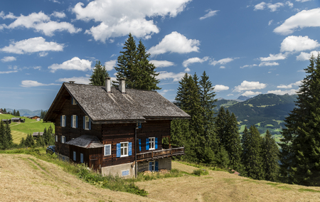 Matschwitz, Austria - July 21, 2017: Old wooden cabin in Matschwitz with in the background the mountains of Montafon on a summers day, Austriaのeditorial素材
