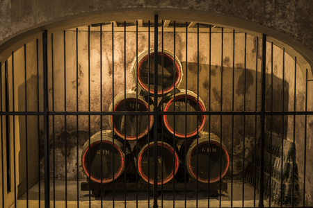Reims, France - June 14, 2017: the caves of Champagne House Mumm with old wooden champagne barrels and bottles behind bars, France.のeditorial素材