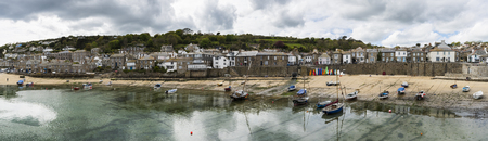 Mousehole, England - April 28, 2017: Panorama of Mousehole with the harbour, houses and the tide, Cornwallのeditorial素材