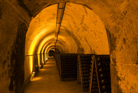 Reims, France - June 14, 2017: the caves of Champagne House Mumm with old pupitres in a long dark corridor, France.のeditorial素材