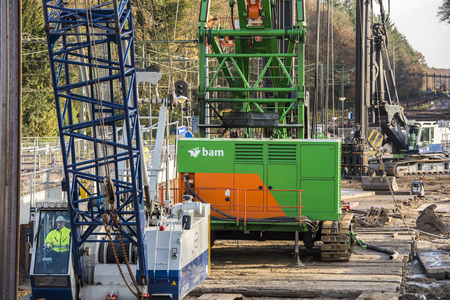 Driebergen, Netherlands - November 26, 2017: Construction site at the railway station in Driebergen, province Utrecht, with cranes and workers.のeditorial素材