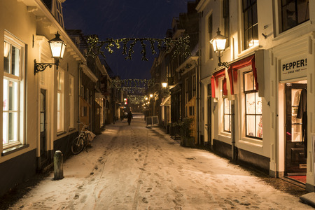 Wijk bij Duurstede, Netherlands - December 11, 2017: Shopping street in december during Xmas and winter with shops and snow.のeditorial素材