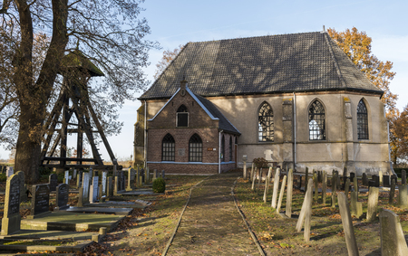 Wanneperveen, The Netherlands - November 24, 2016: Church in Wanneperveen with the graveyard and the 'Klokkenstoel'.のeditorial素材