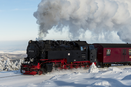 Brocken, Germany - February 5, 2018: Steam locomotive of the Harzer Schmallspurbahnen in wintertime with snow on the mountain Brocken in Saksen-Anhalt.のeditorial素材