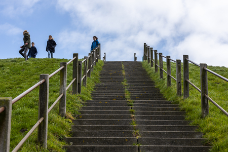 Hoek van Holland, The Netherlands - April 5, 2018: Children playing on a hill with stairs in early spring.のeditorial素材