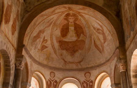 Gourdon, France - August 3, 2018: Interior with frescoes (Christ on throne) of the Romanesque church...