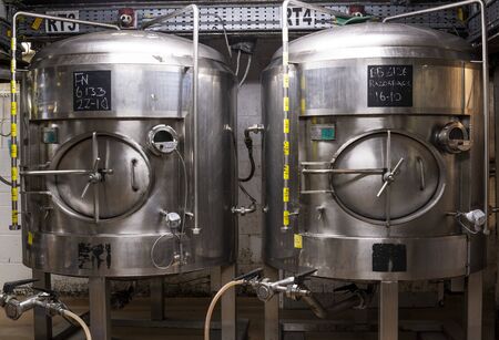 Ringwood, England - October 26, 2018: Production of beer at the Ringwood Brewery with stainless steel barrels and pipes.のeditorial素材